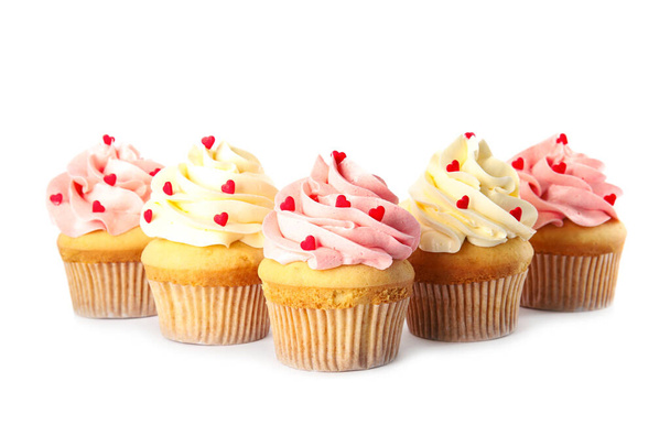 Tasty cupcakes with heart shaped sprinkles on white background. Valentine's Day celebration - Zdjęcie, obraz
