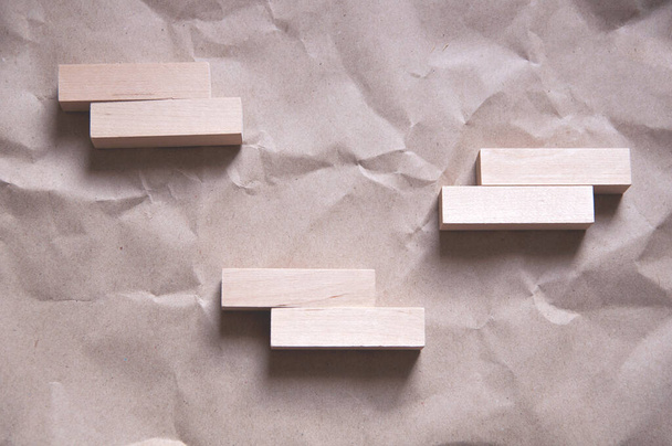 fondo de papel artesanal arrugado con rectángulos de madera dispuestos en un cierto orden en un estilo minimalista - Foto, imagen