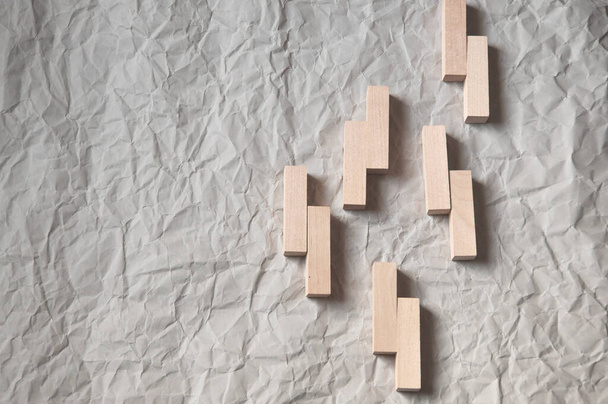 background of crumpled craft paper with wooden rectangles arranged in a certain order in a minimalist style - Photo, Image
