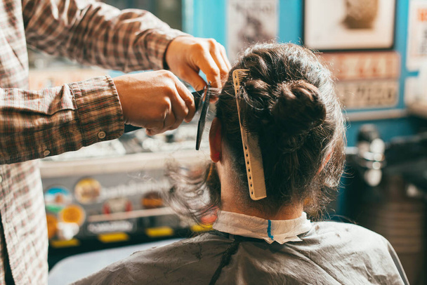 Фото парикмахера, работающего над стрижкой в салоне - Фото, изображение