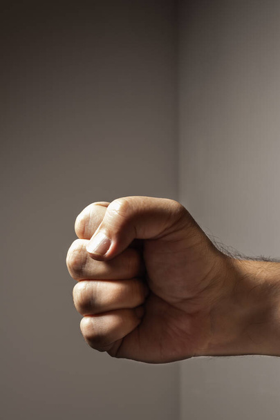 Clenched fist of a white male forward and sideways. Concepts of strength and anger. - Photo, Image