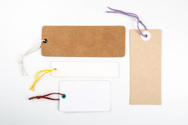 Cardboard and paper price tags on a white background. Copy space, mock up - Photo, Image