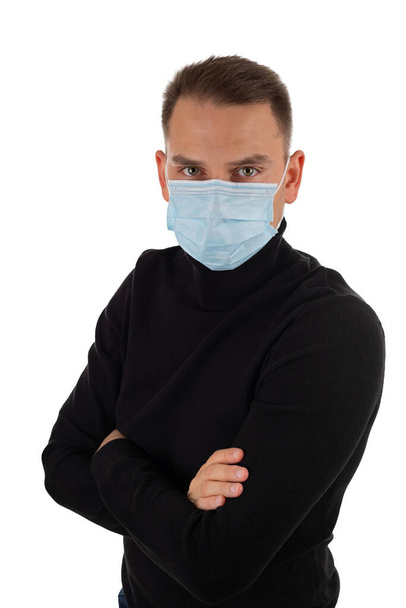 Picture of young caucasian man is wearing surgical mask on isolated background - Foto, Bild