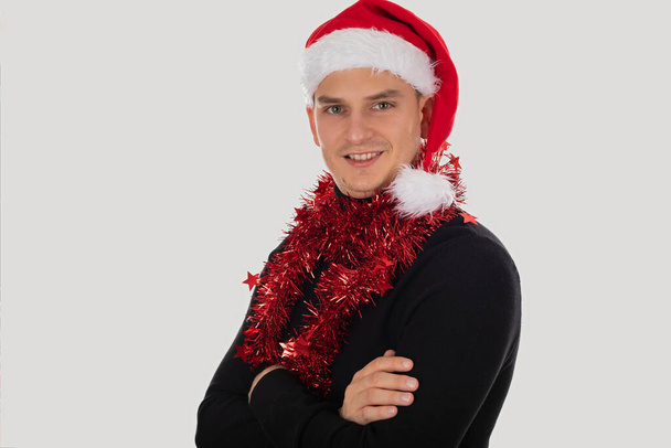 Picture of handsome young caucasian Santa Claus posing on isolated background - Foto, afbeelding
