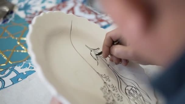 Painter is painting homemade tile porcelain. - Footage, Video