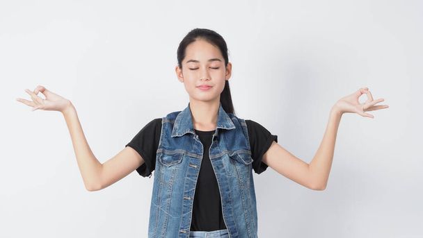 Gesture posing. Asian Young woman on white background cheerful and confident showing gestures. such as mini heart Okay Thumb up or point out. very happy amazed excited and surprised, Jacket jeans.  - Foto, imagen
