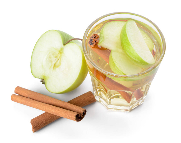 Tasty apple drink with cinnamon in glass on white background - Photo, Image