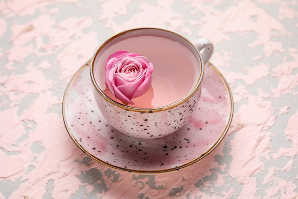 Taza de té con rosa sobre fondo de color - Foto, imagen