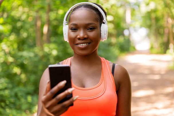 african american woman with headphones and phone - Foto, Imagen