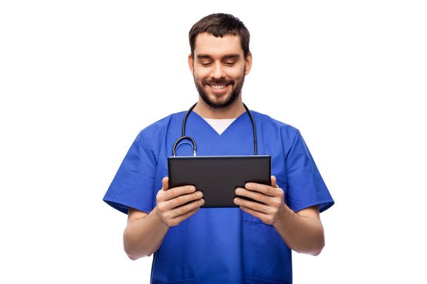 smiling doctor or male nurse using tablet computer - Foto, imagen