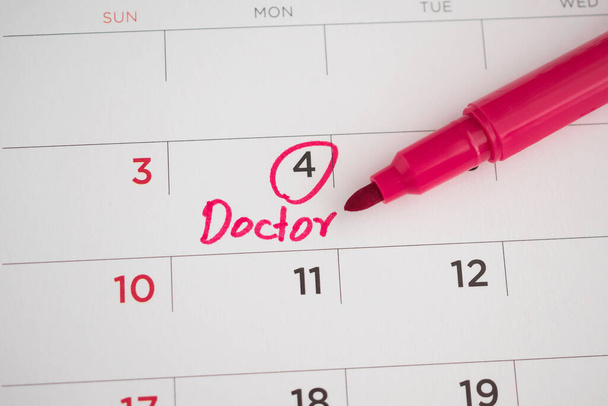 important doctor appointment schedule write on white calendar page date close up - Photo, Image