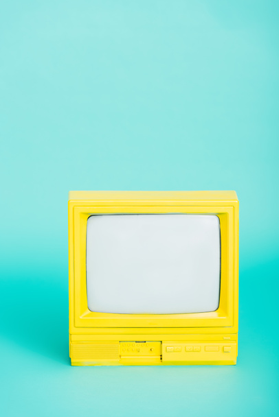 bright yellow retro tv on turquoise background - Φωτογραφία, εικόνα