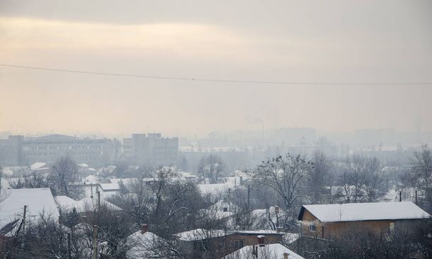 Paysage vue sur la ville de village enneigée d'hiver dans le gel et le soleil - Photo, image