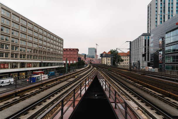 Elevated train tracks in train station amidst buildings in Berlin - Photo, image