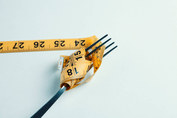 Dieting concept with fork and meter - Foto, imagen