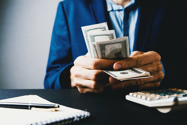 man counts money calculating finance - Фото, изображение