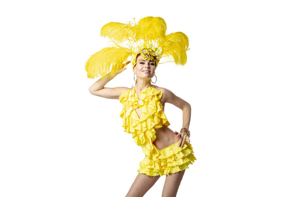 Beautiful young woman in carnival, stylish masquerade costume with feathers dancing on white studio background. - Foto, imagen
