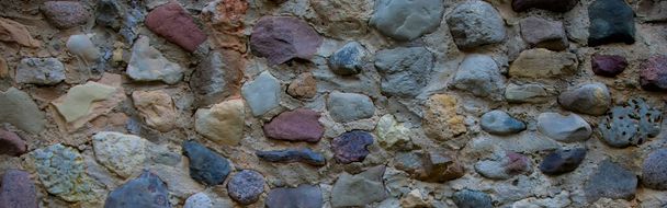 Banner wall from multi-colored large stones boulders. - Photo, Image