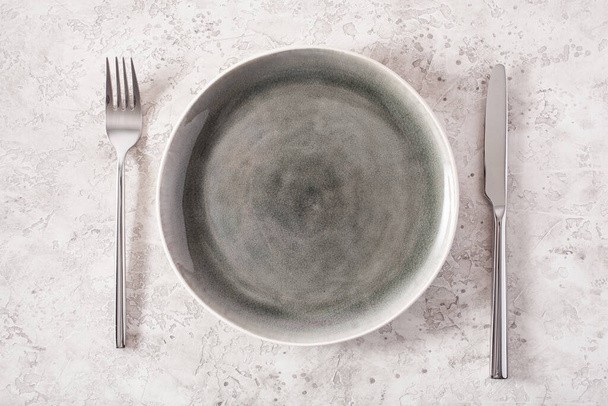 empty plate fork knife on concrete background - Photo, Image