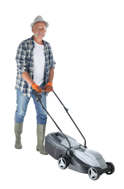Senior man with modern lawn mower on white background - Foto, Imagen
