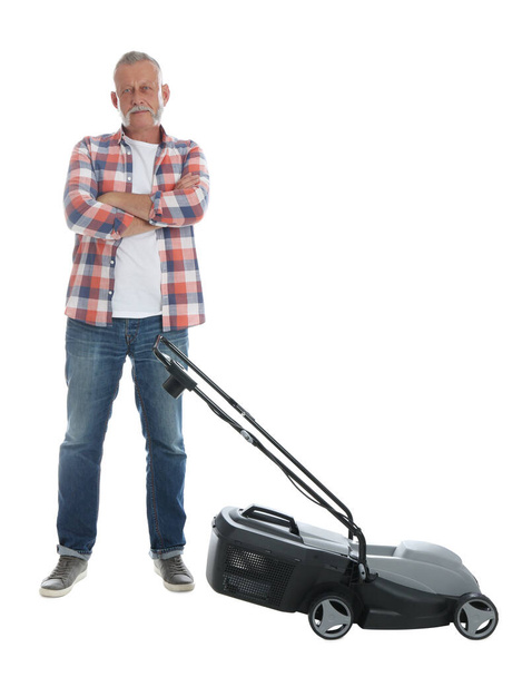 Senior man with modern lawn mower on white background - Foto, Imagen