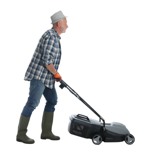 Senior man with modern lawn mower on white background - Foto, Imagem
