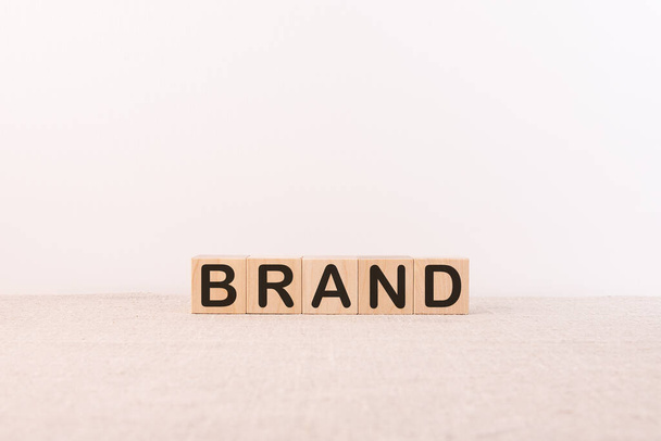 Wooden cubes with the word BRAND. Corporate identity, marketing, business. - Φωτογραφία, εικόνα