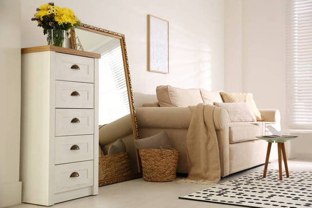 Large mirror and comfortable sofa in living room. Interior design - Фото, изображение