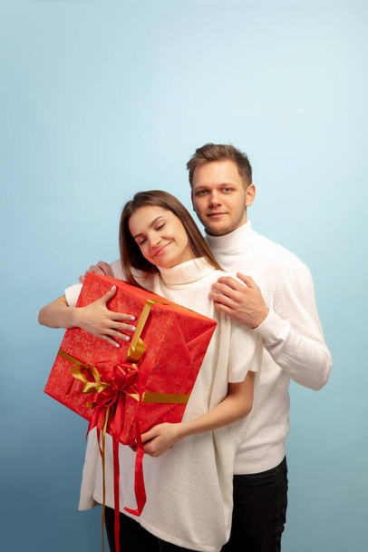 Beautiful couple in love on blue studio background. Valentines Day, love and emotions concept - Photo, Image