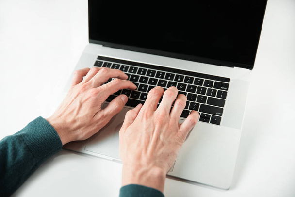 close up. casual male typing on a laptop keyboard. - Foto, Bild
