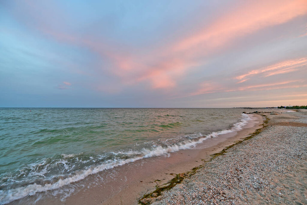 Beautiful evening sunset on the beach of the sea of azov. Colorful colors of sky and sea. - Fotografie, Obrázek