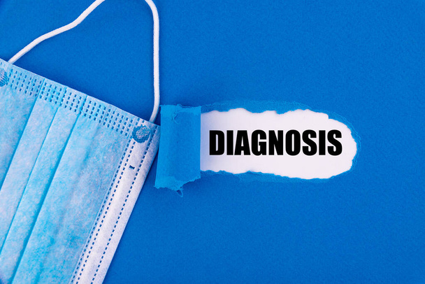 The text DIAGNOSIS appearing behind torn blue paper. - Fotoğraf, Görsel