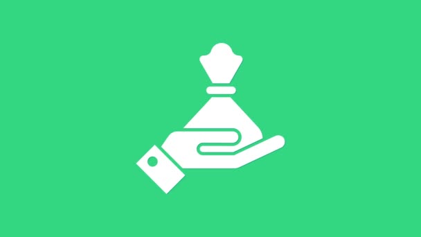 Biała Ręka trzyma ikonę worka z pieniędzmi na zielonym tle. Symbol dolara lub USD. Znak waluty Cash Banking. 4K Animacja graficzna ruchu wideo - Materiał filmowy, wideo