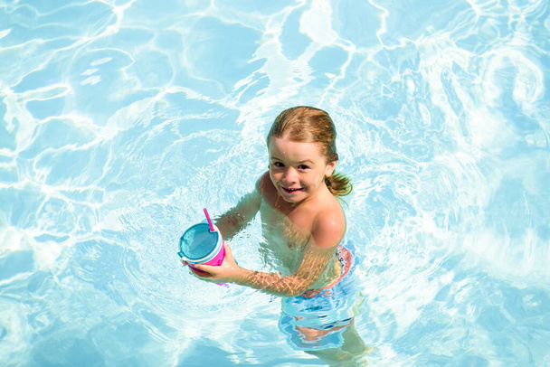 Kid swimming in pool. Children summer vacation. Summertime. Attractions concept. Swimmingpool. - Photo, Image