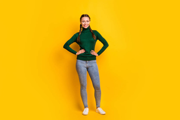 Photo portrait full body view of confident woman in green sweater isolated on vivid yellow colored background - Foto, Imagem