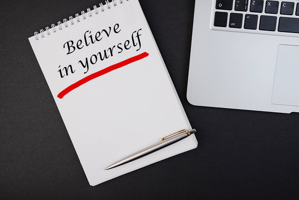 Business concept - Top view notebook writing Believe in yourself - Foto, Imagen