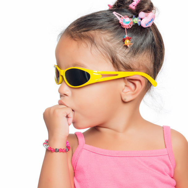 Multiracial small girl  wearing yellow sunglasse - Фото, изображение