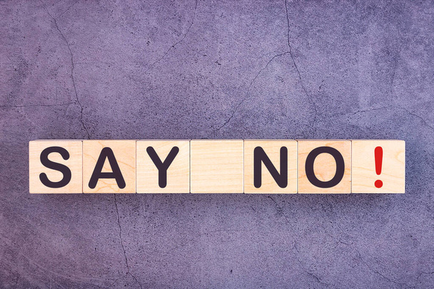SAY NO word written on wood block on a grey background - Foto, imagen
