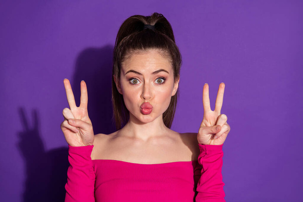 Photo of charming lovely sweet girl send air kiss make v-sign isolated over vivid color background - Foto, immagini
