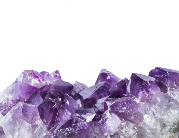 Close up view of large violet amethyst crystal cluster border isolated with white background. Esoteric magical background concept. - Φωτογραφία, εικόνα