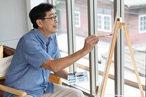 senior asian man painting at home - Photo, Image