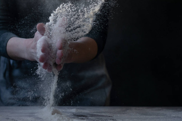 Woman baker with flour in her hands - Photo, Image
