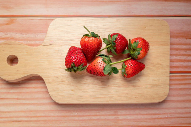 Fresh strawberries on wood cutting board. vegan food. healthy food concept - Foto, Bild
