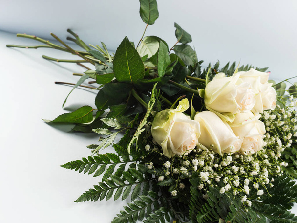 Ramo de rosas blancas como regalo en unas vacaciones en gris - Foto, Imagen