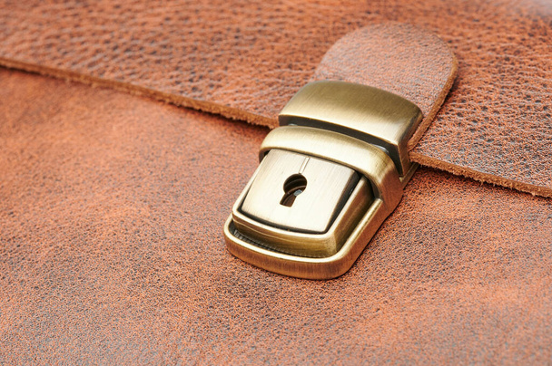 Metal security buckle leather  bag macro close up view - Fotó, kép