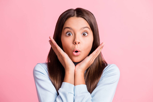 Close up photo of shocked pupil girl open mouth palms chin wear blue turtleneck isolated on pink color background - Foto, afbeelding