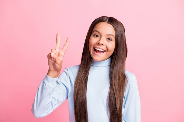 Close-up portrait of attractive glad cheerful girl showing v-sign having fun isolated over pink pastel color background - Valokuva, kuva