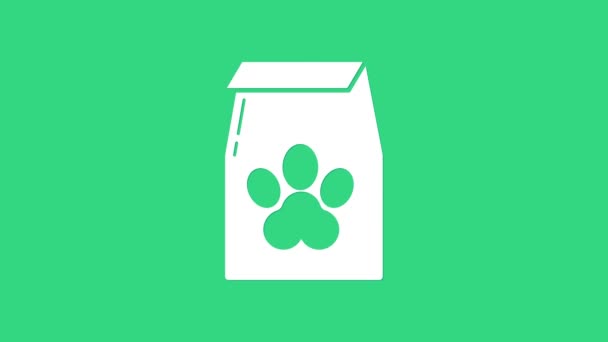 Bolsa blanca de comida para mascota icono aislado sobre fondo verde. Comida para animales. Paquete de alimentos para mascotas. Huella de pata de perro o gato. Animación gráfica de vídeo 4K - Metraje, vídeo