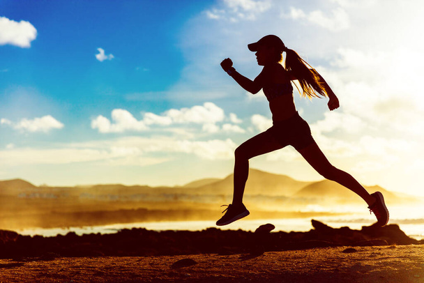 Silhouette athlete runner running in sunset - 写真・画像