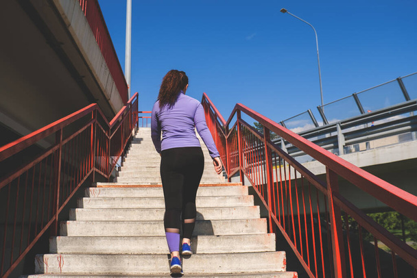 back view young woman running on the stairs, sport concept - Foto, Bild